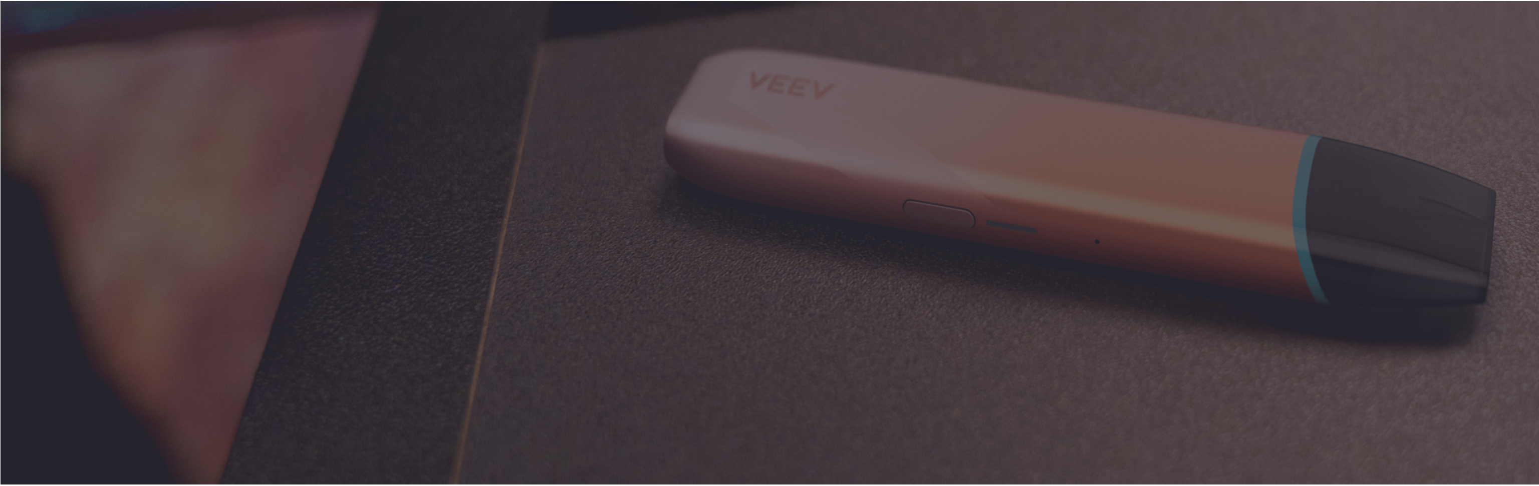 Garnet Red IQOS ILUMA i PRIME device above its charger